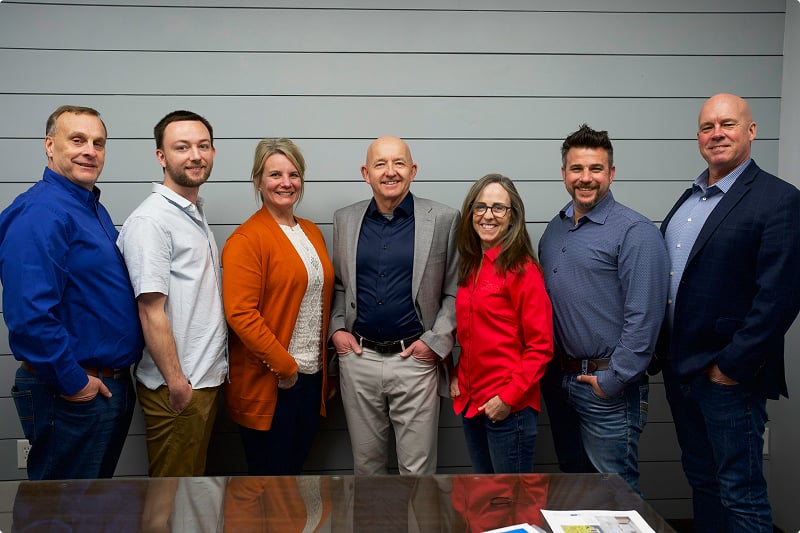 Titus Contracting owners Lee Lawrence, Suzanne Rajavuori, and Scott Rajavuori with team members at their Burnsville Minnesota office