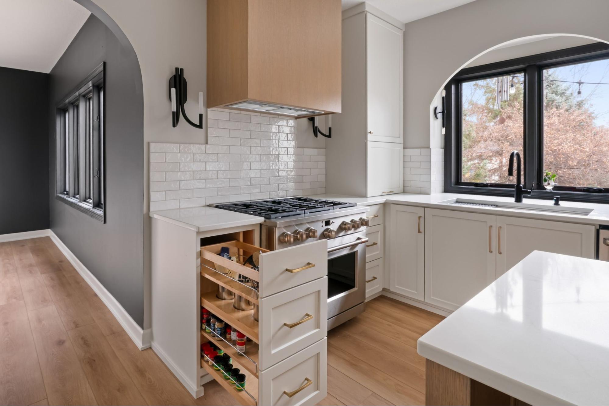a cabinet being pulled out, showcasing custom spice storage