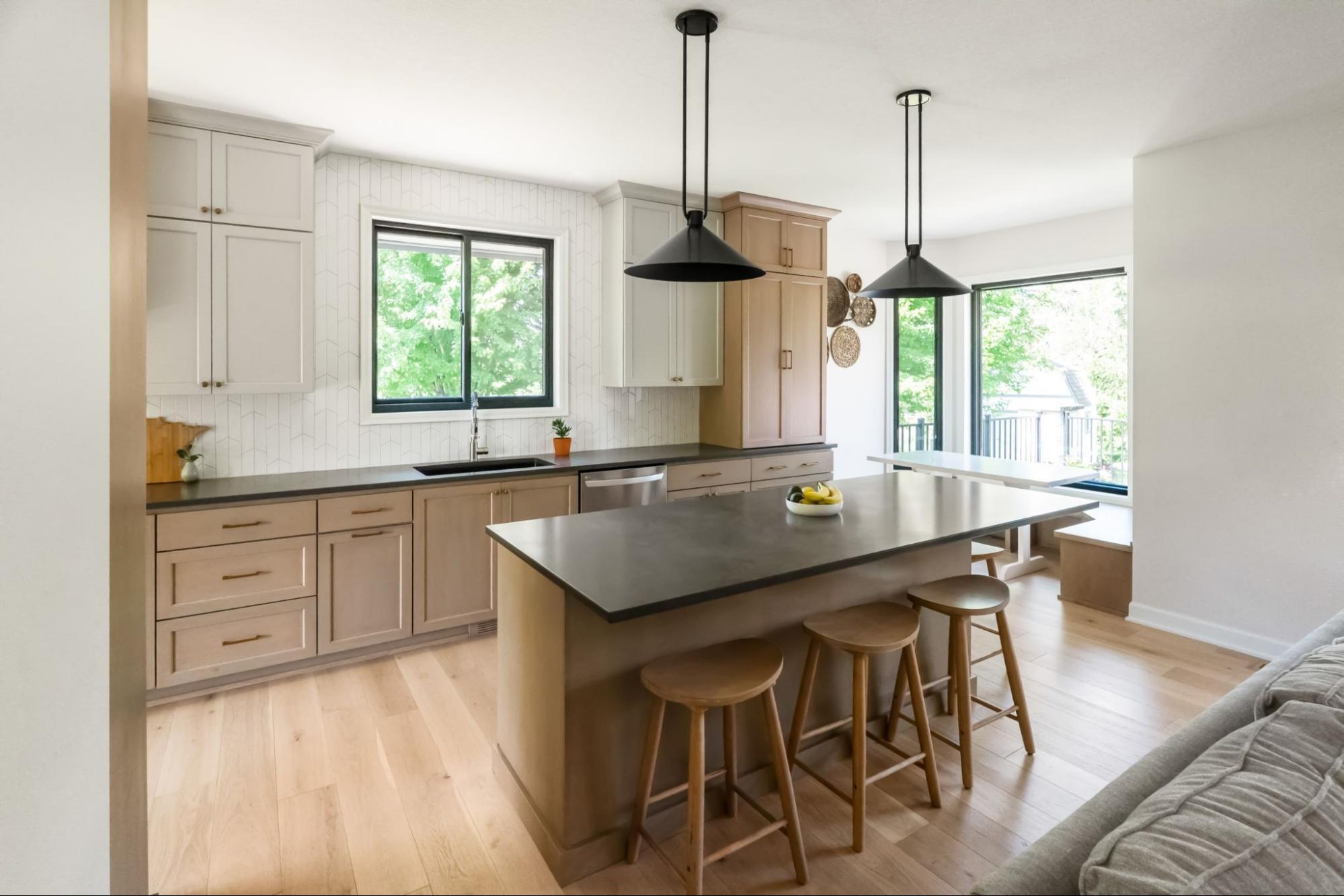 a bright and airy kitchen with white cabinets, warm brown countertops, and dark countertops.