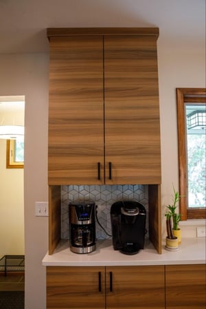 a coffee bar with vertical cabinets