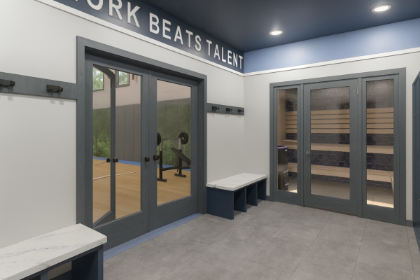 inside a home wellness addition, with a view into two rooms: first is an indoor sport court with flex workout space. The second is a inside sauna. 