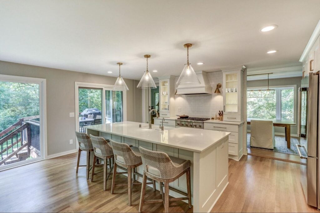 kitchen with a white island and statement lights