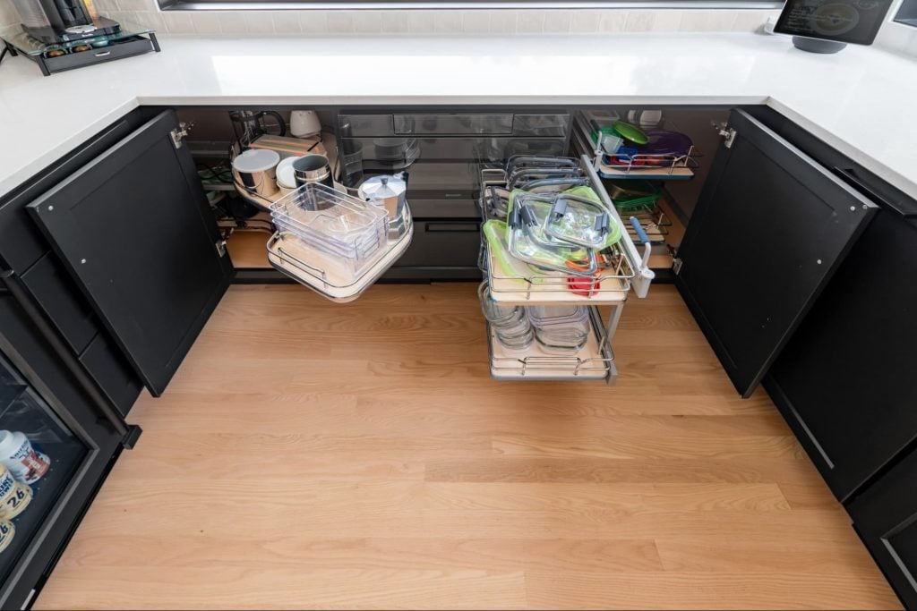 an overhead view of kitchen cabinets with pull-out features. shelves come away from the cabinet and swivel, providing more room for storage and easy access to the items inside.