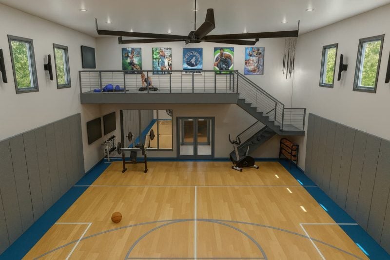 a view of a workout area in a wellness space. a large basketball court is flanked by workout equipment, with a loft area for yoga and stretching.
