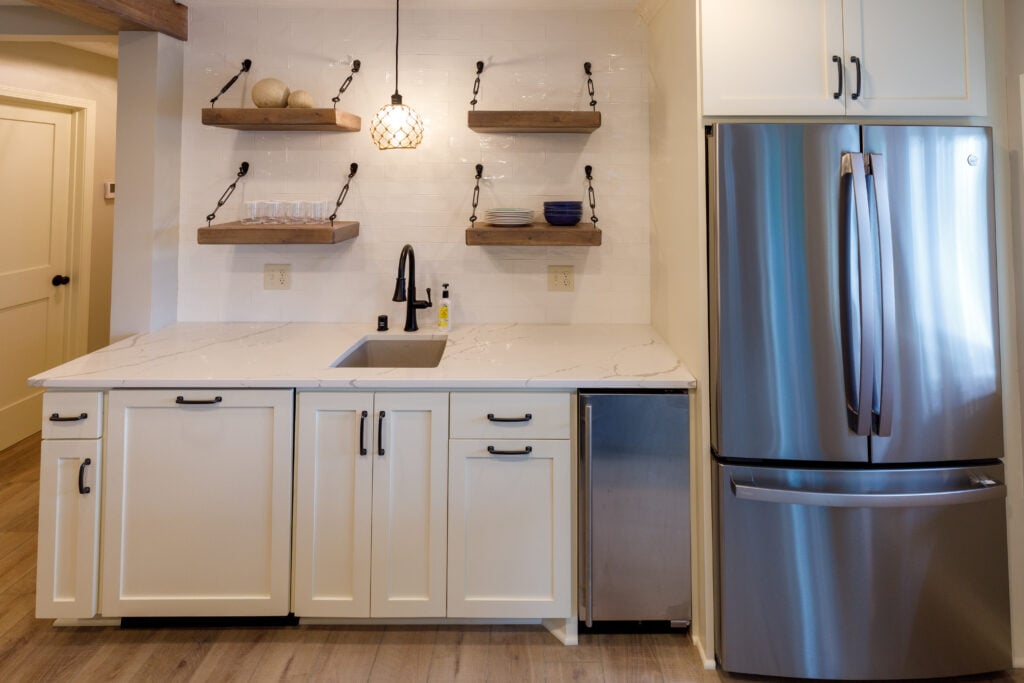 wet bar with full fridge and open shelving