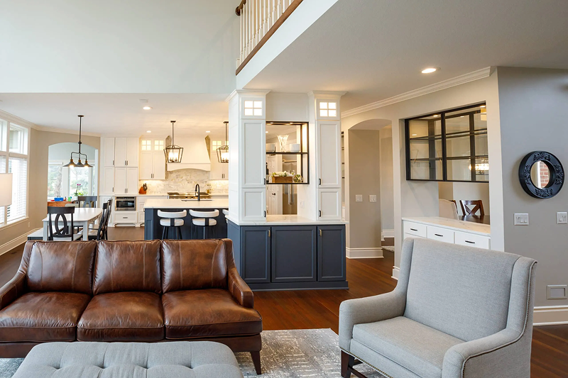 Minnesota whole home remodel with open concept kitchen, navy island, white cabinetry, and connected living and dining areas