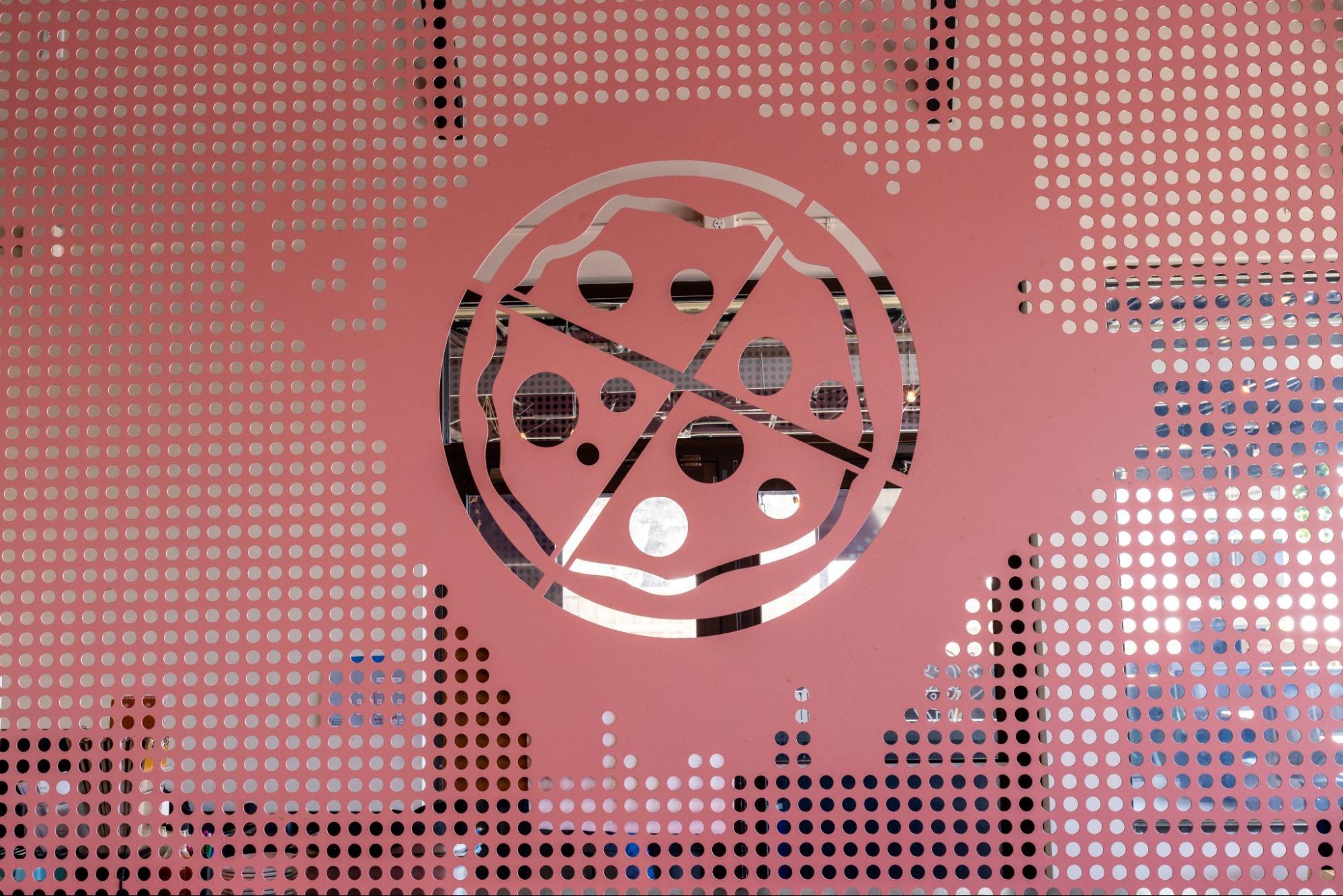 close-up of pink perforated divider with pig ate my pizza logo