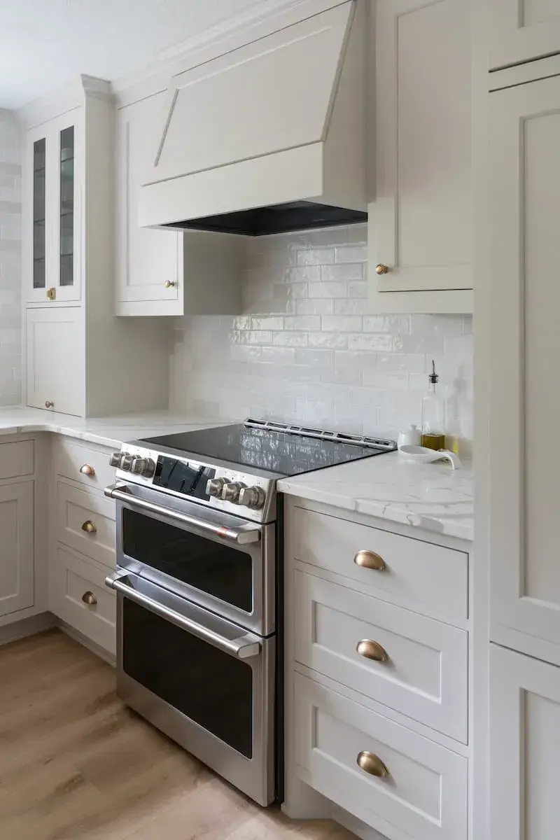 custom cabinet with double oven and antique gold hardware
