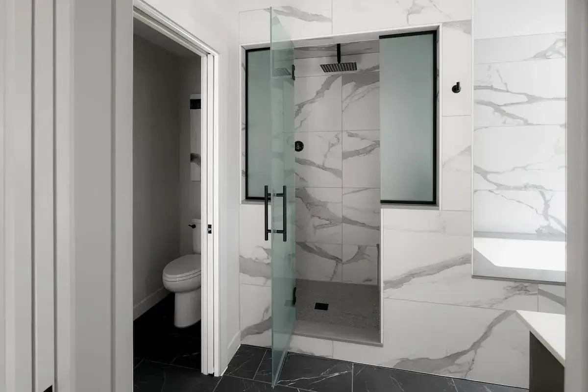 walk in shower with overhead shower head and built in shelving