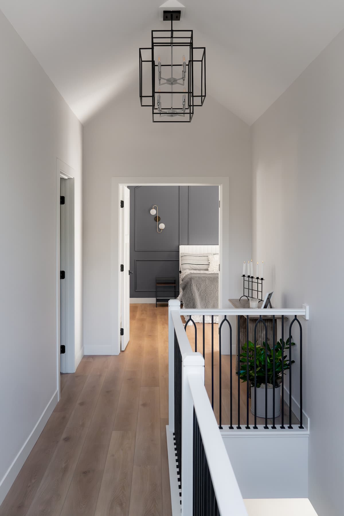 upper floor hallway with view into primary bedroom