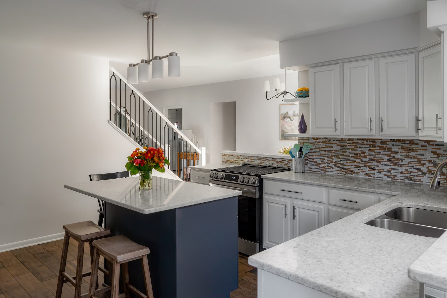 a kitchen area leading upstairs