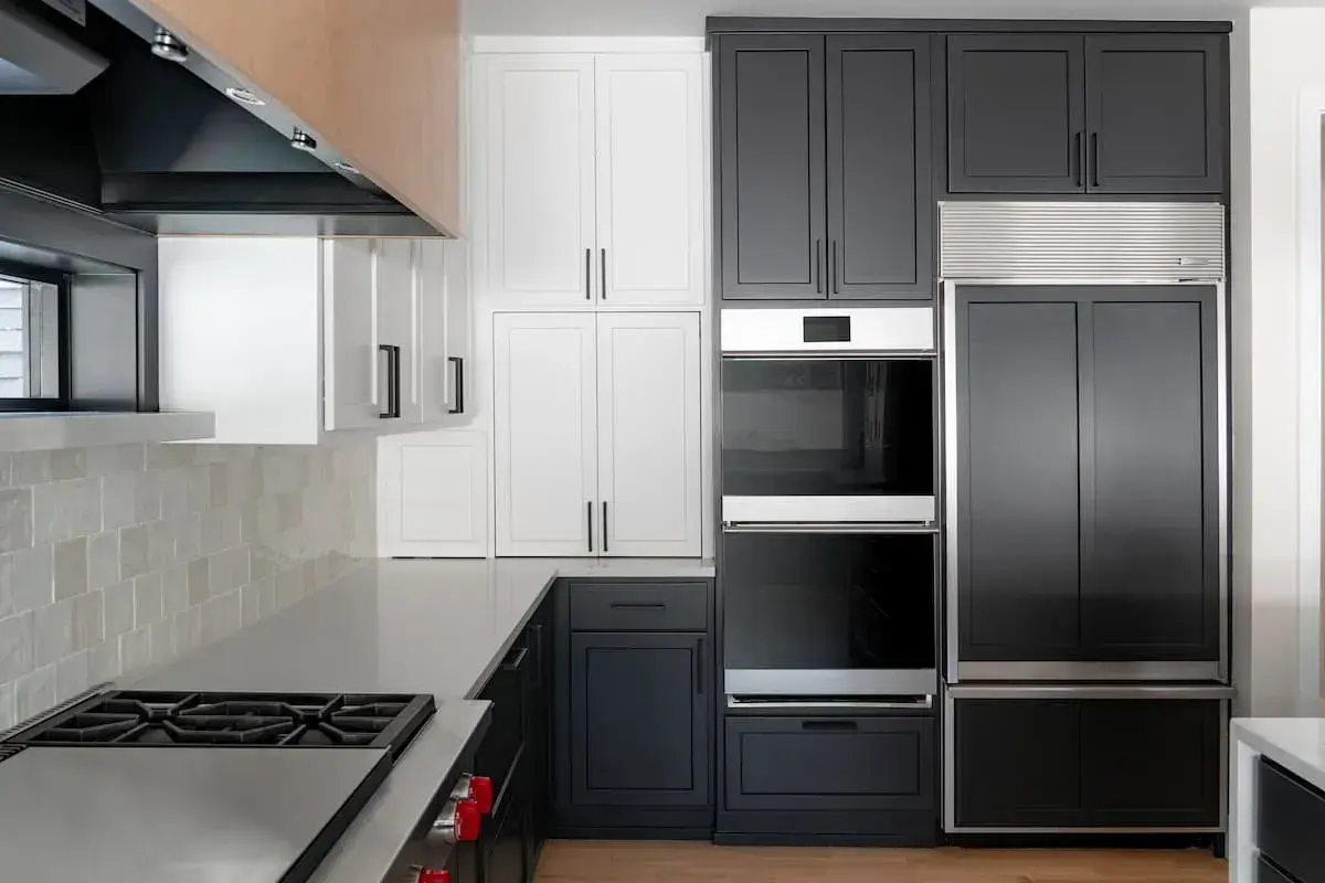 dual ovens with white and black painted cabinetry
