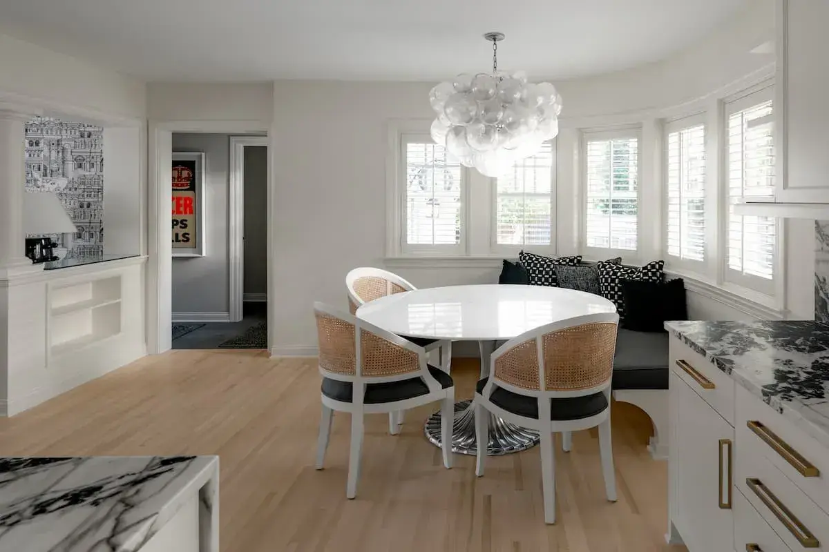 dining nook area with statement lighting a kitchen and dining area with an open concept plan.