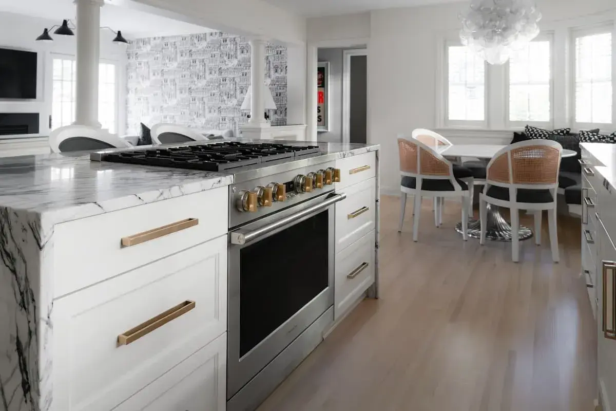 view of stove and dining nook area with statement lighting a kitchen and dining area with an open concept plan.