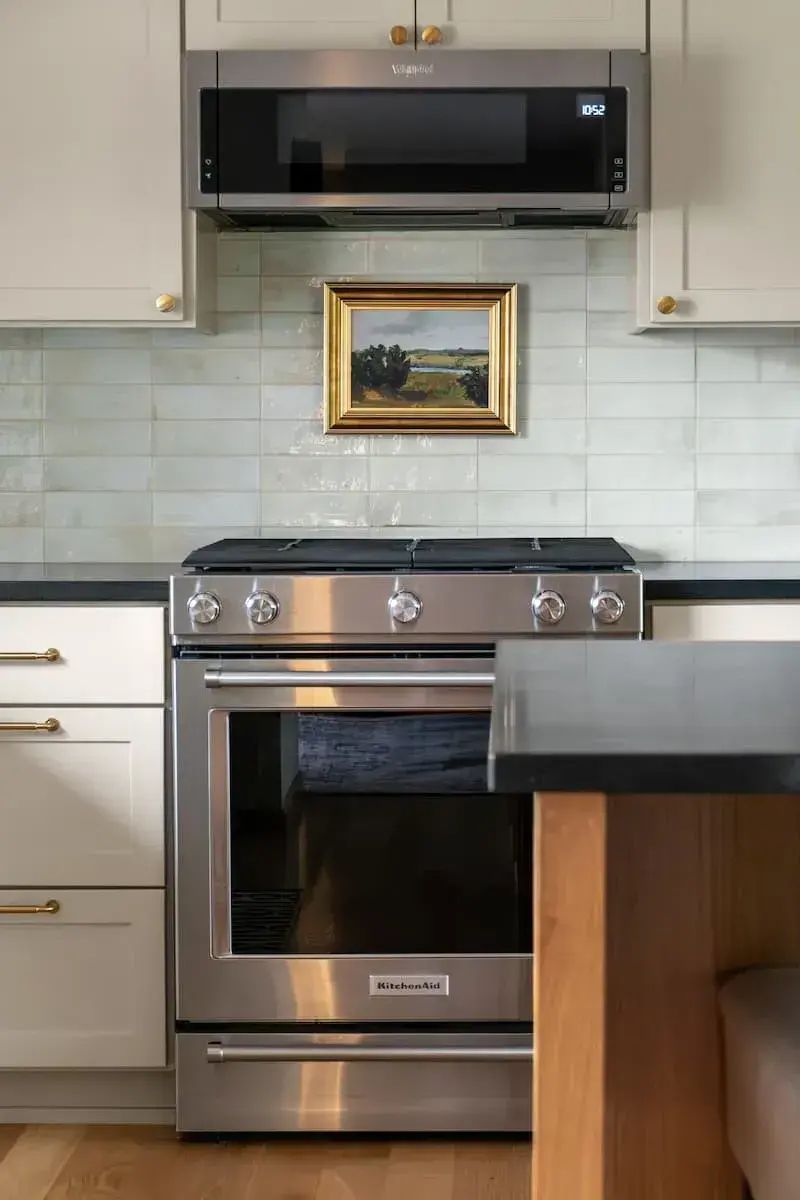 Tile backsplash with white cabinets in new kitchen