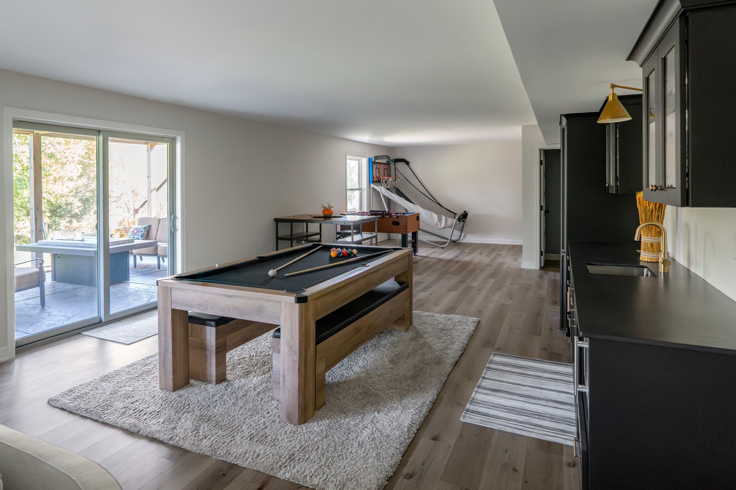 a basement with pool table and games