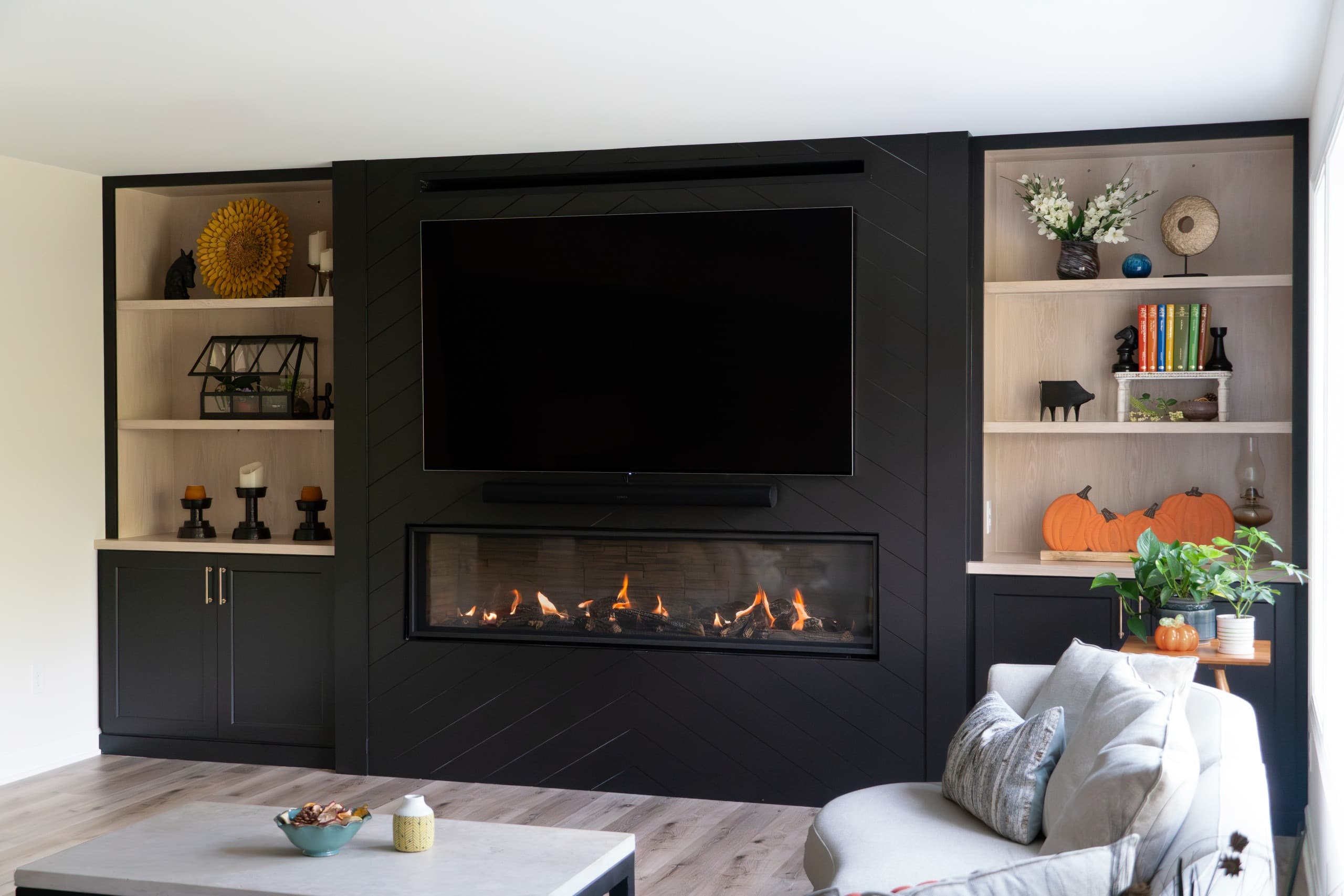 a full wall with a built-in, featuring a fireplace, tv, and open shelves