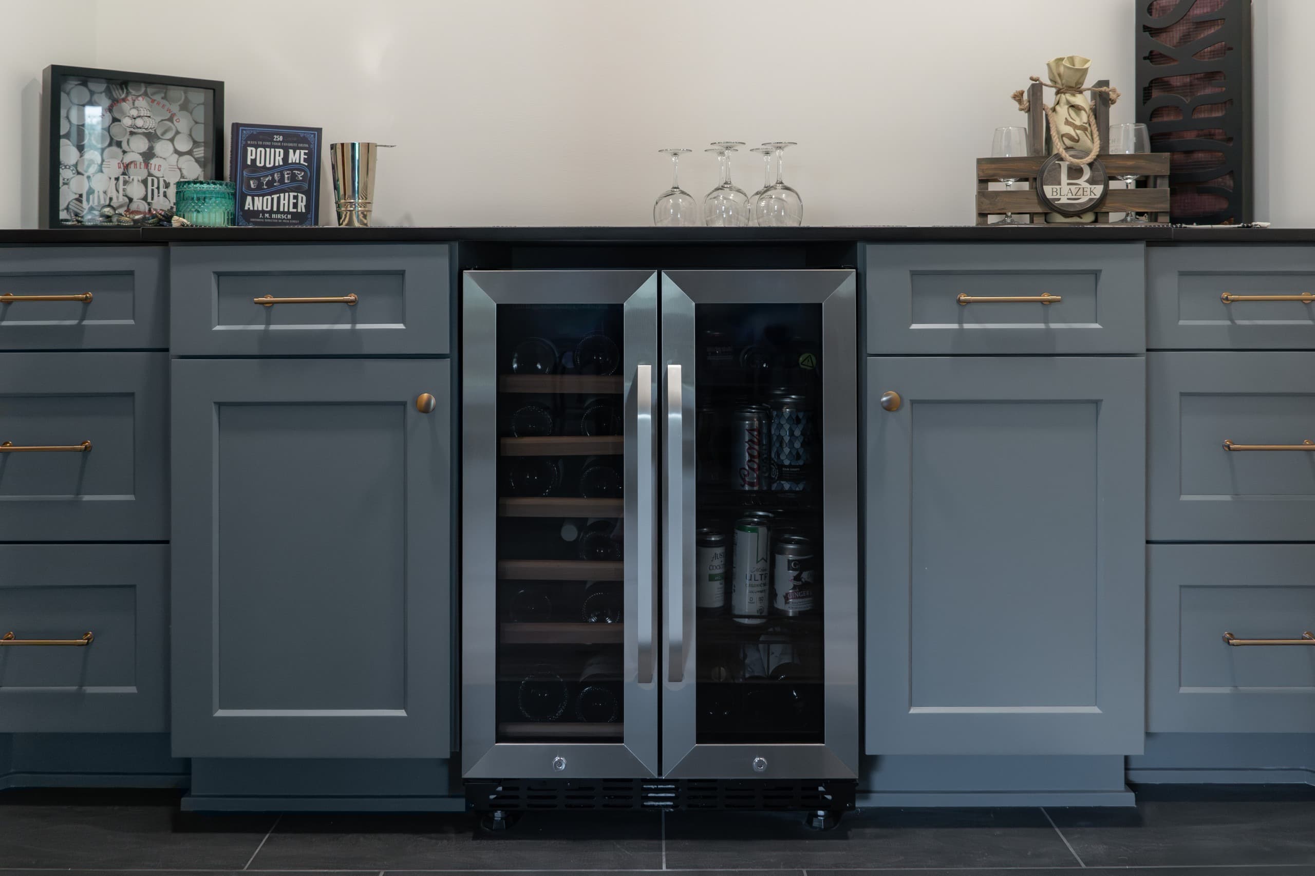 a wine cellar in a basement with blue cabinets