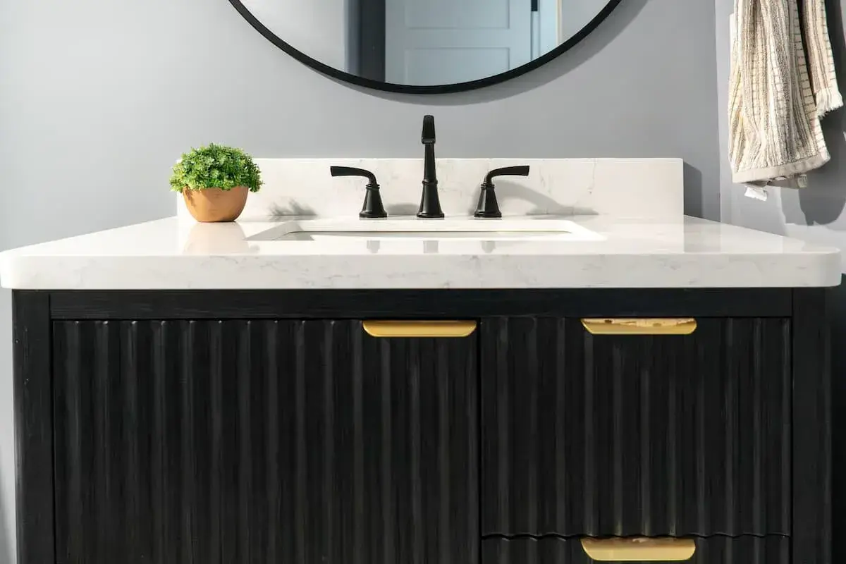 scalloped black vanity with gold hardware