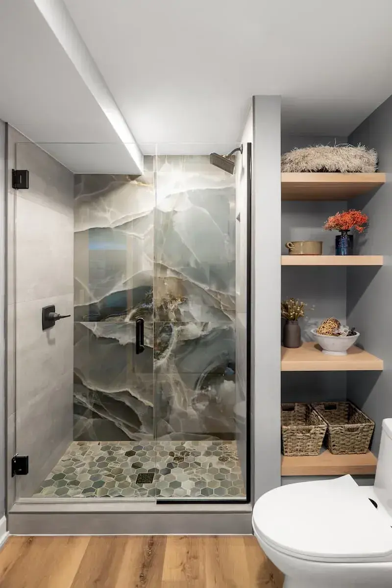Large format tile in shower and built in open wall shelving