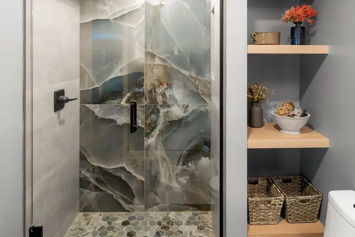 Large format tile in shower and built in open wall shelving