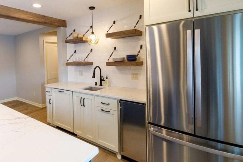 This basement kitchenette takes advantage of every inch with fridge, sink, dishwasher, and plenty of space to entertain