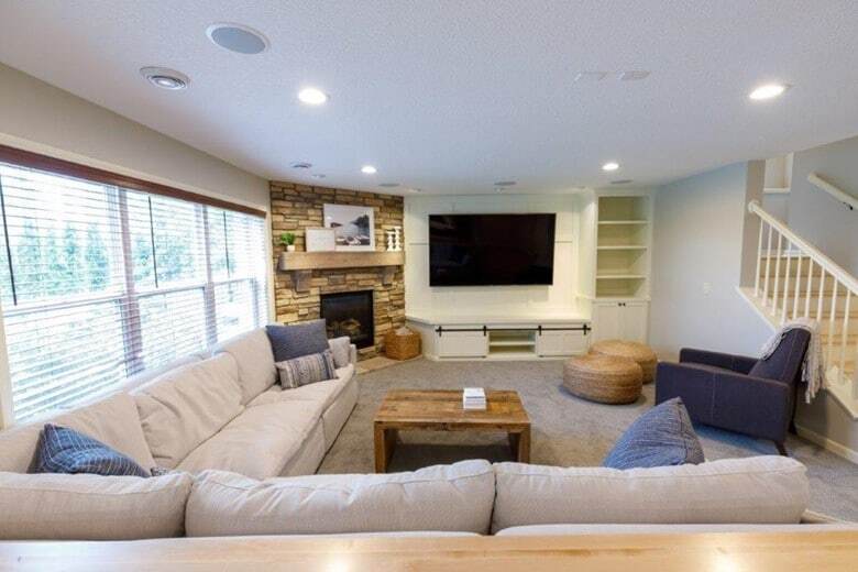 For this Minneapolis lower-level upgrade, our design team mixed custom solutions with low-cost design tricks for an elevated basement family room.