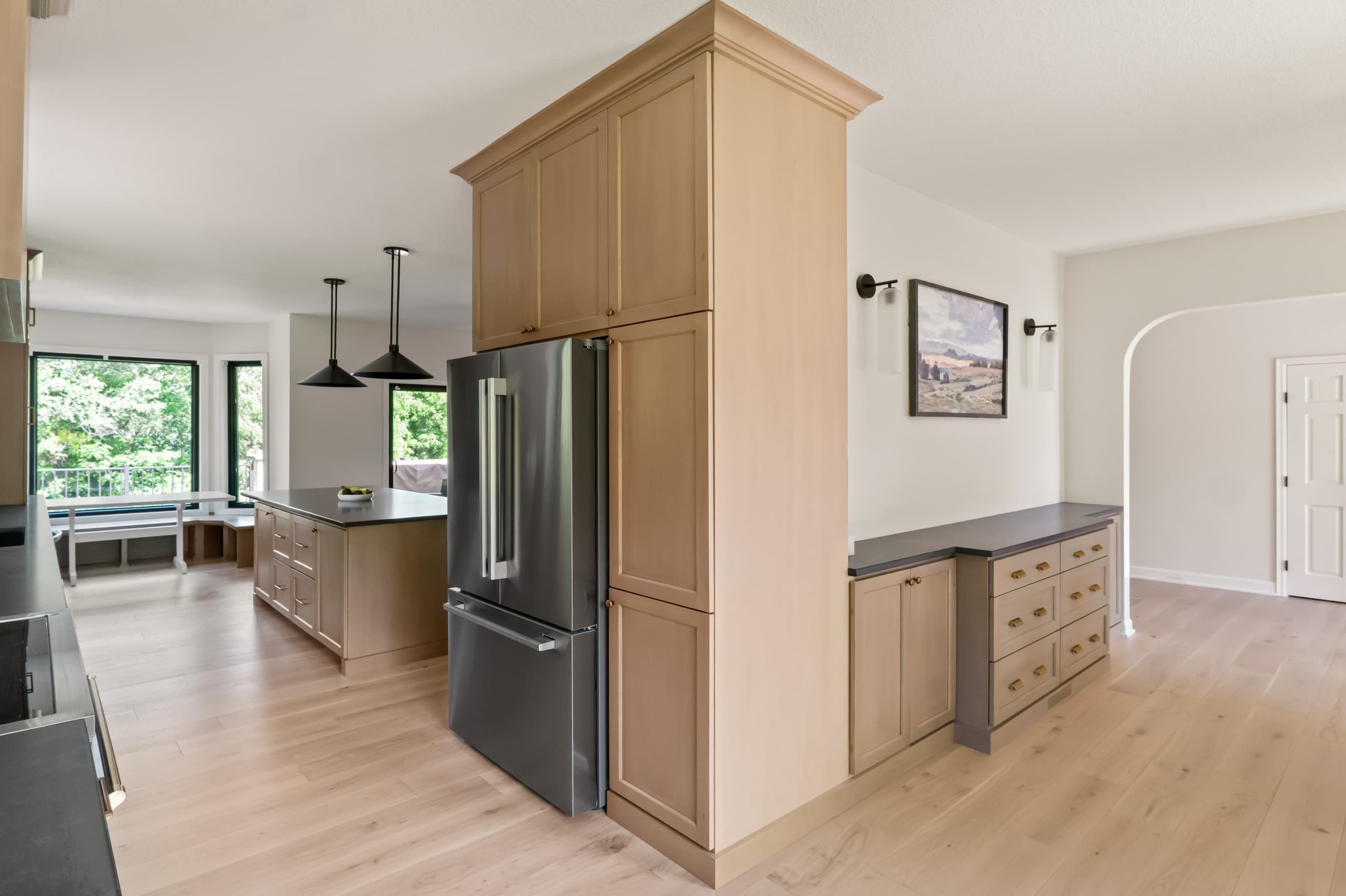 a chic boho kitchen with taupe cabinets and warm gray countertops
