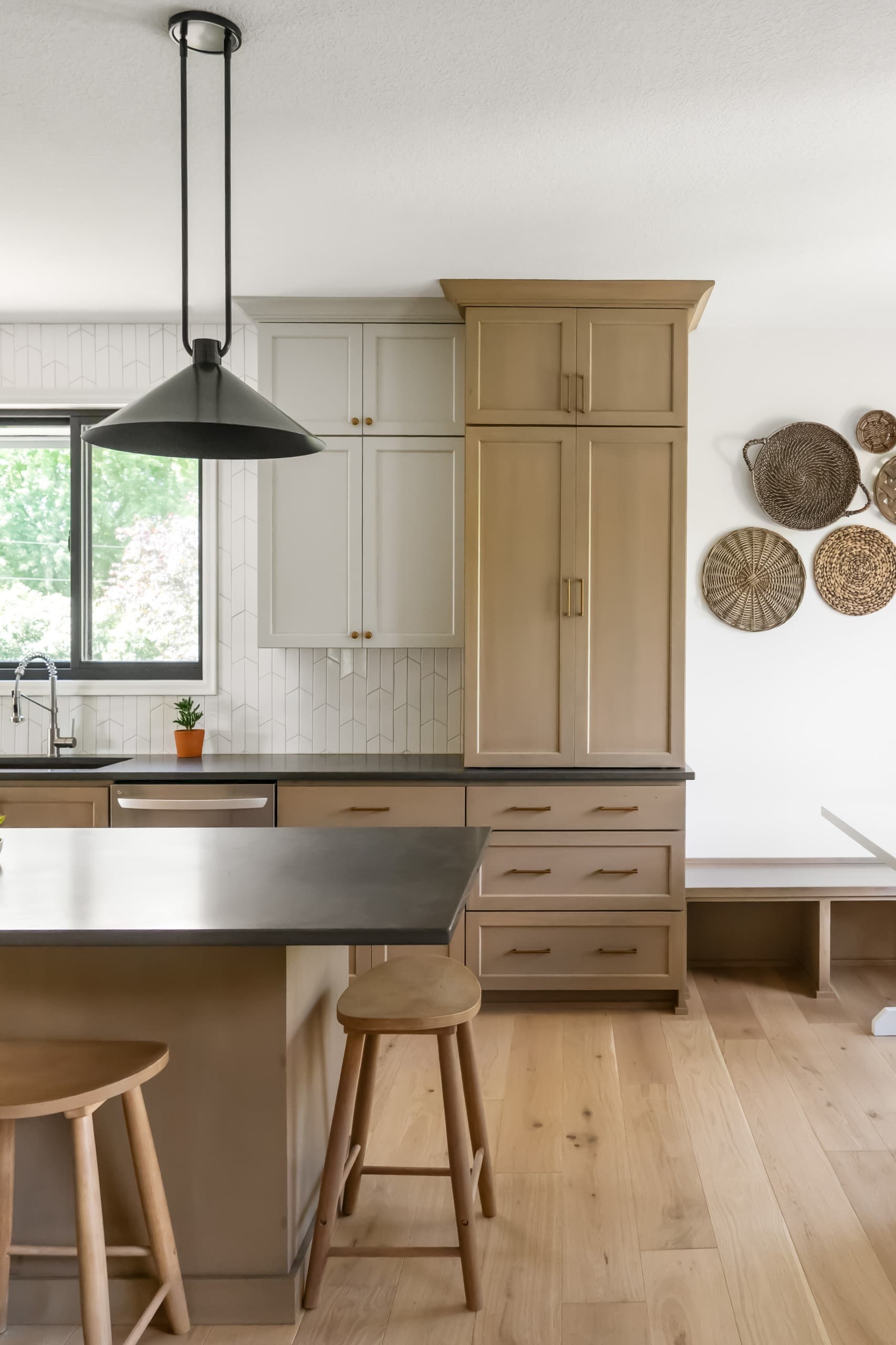 a chic boho kitchen with taupe cabinets and warm gray countertops