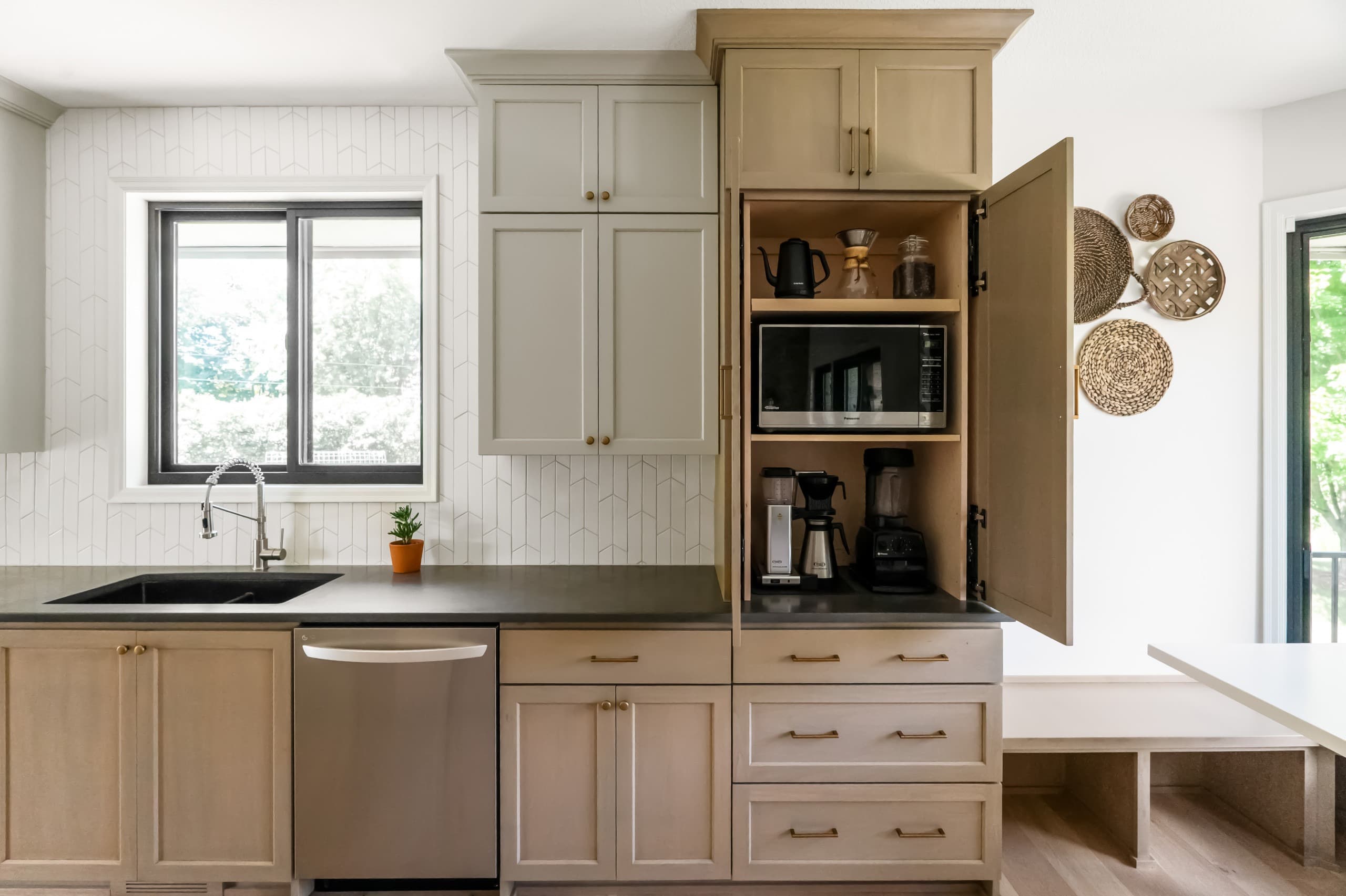 a chic boho kitchen with taupe cabinets and warm gray countertops