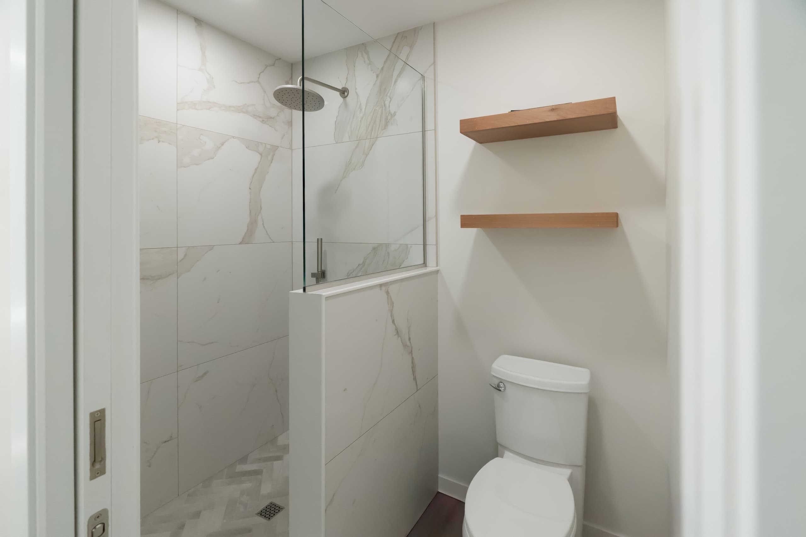 a bathroom with light cream stone tile shower