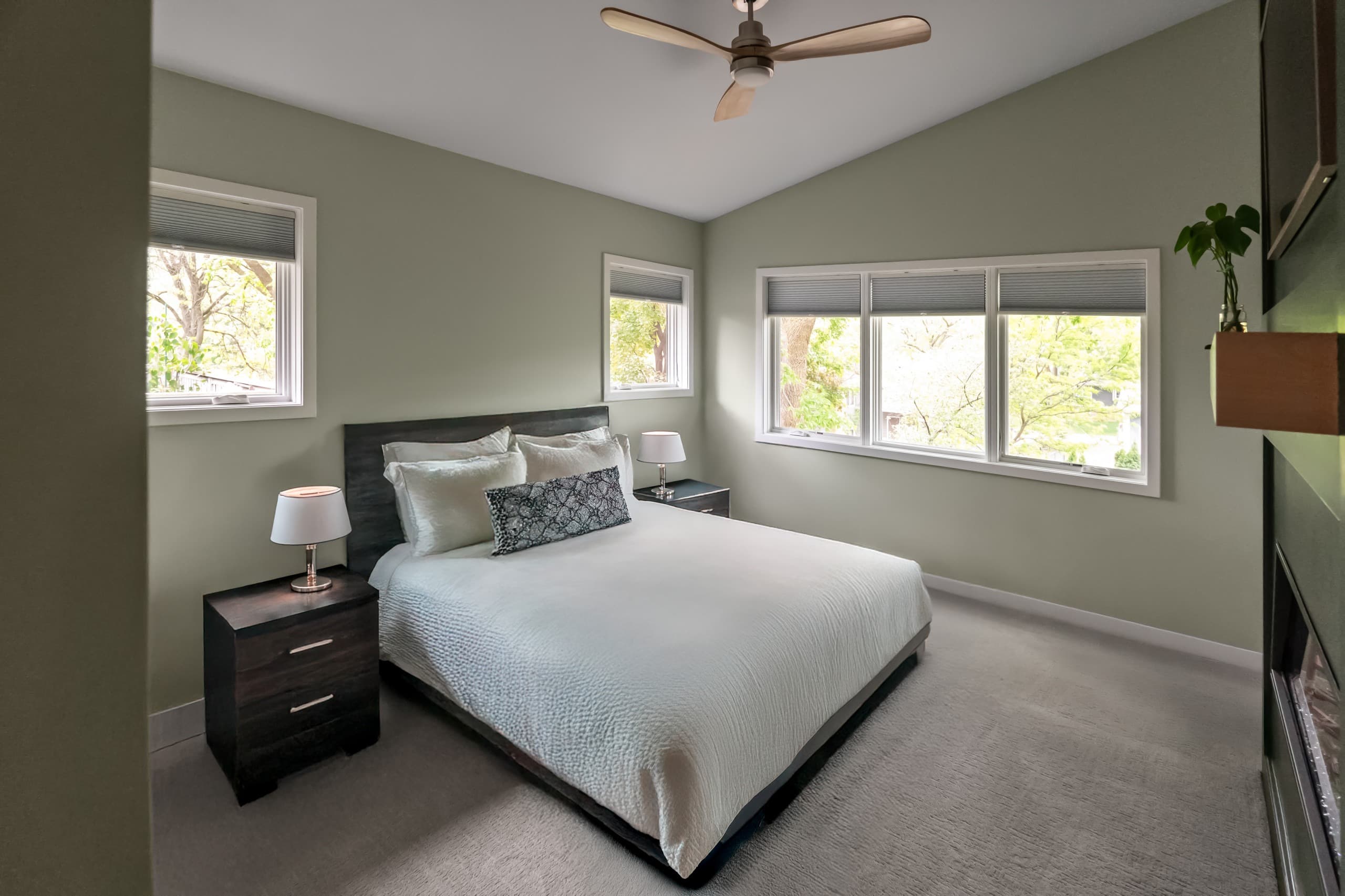 a bedroom with light green walls